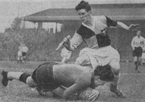 Casuals 'keeper Paul Ahm dives at the feet of Frank Smith