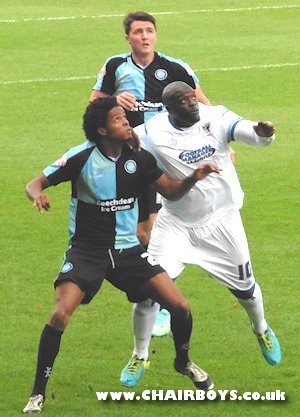 Wanderers Sido Jombati challenges with Dons Adebayo Akinfenwa, Peter Murphy looking on