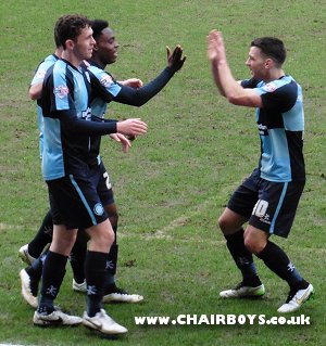 Matt Bloomfield high fives Fred Onyedinma after the Millwall loanee bagged the opener for Wanderers