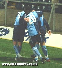 Darren Currie is congratulated by Craig Faulconbridge and Gavin Holligan after scoring Wanderers' equaliser