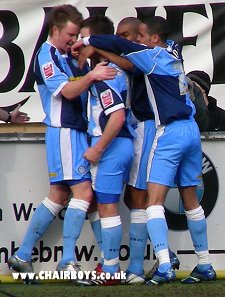 Wycombe players celebrate Matt Bloomfield's opener against Shrewsbury