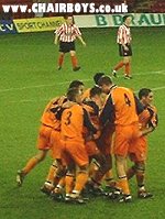 Lewis Cook is mobbed after scoring his second and Wanderers third goal