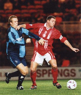 Paul Emblen scored his first goal for Wycombe in the game with Wigan. Here he is in action against that fat bloke earlier in the season - Picture with kind permission of Paul Dennis - Tel 01622-735143 - Do not republish without prior arrangement